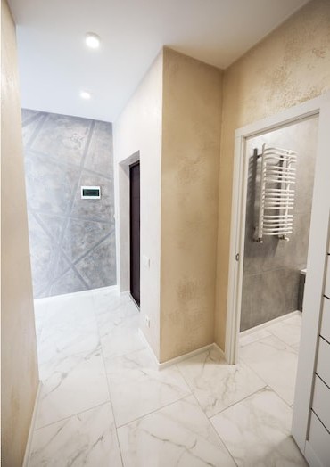 After: finished hallway with marble tile and fixtures